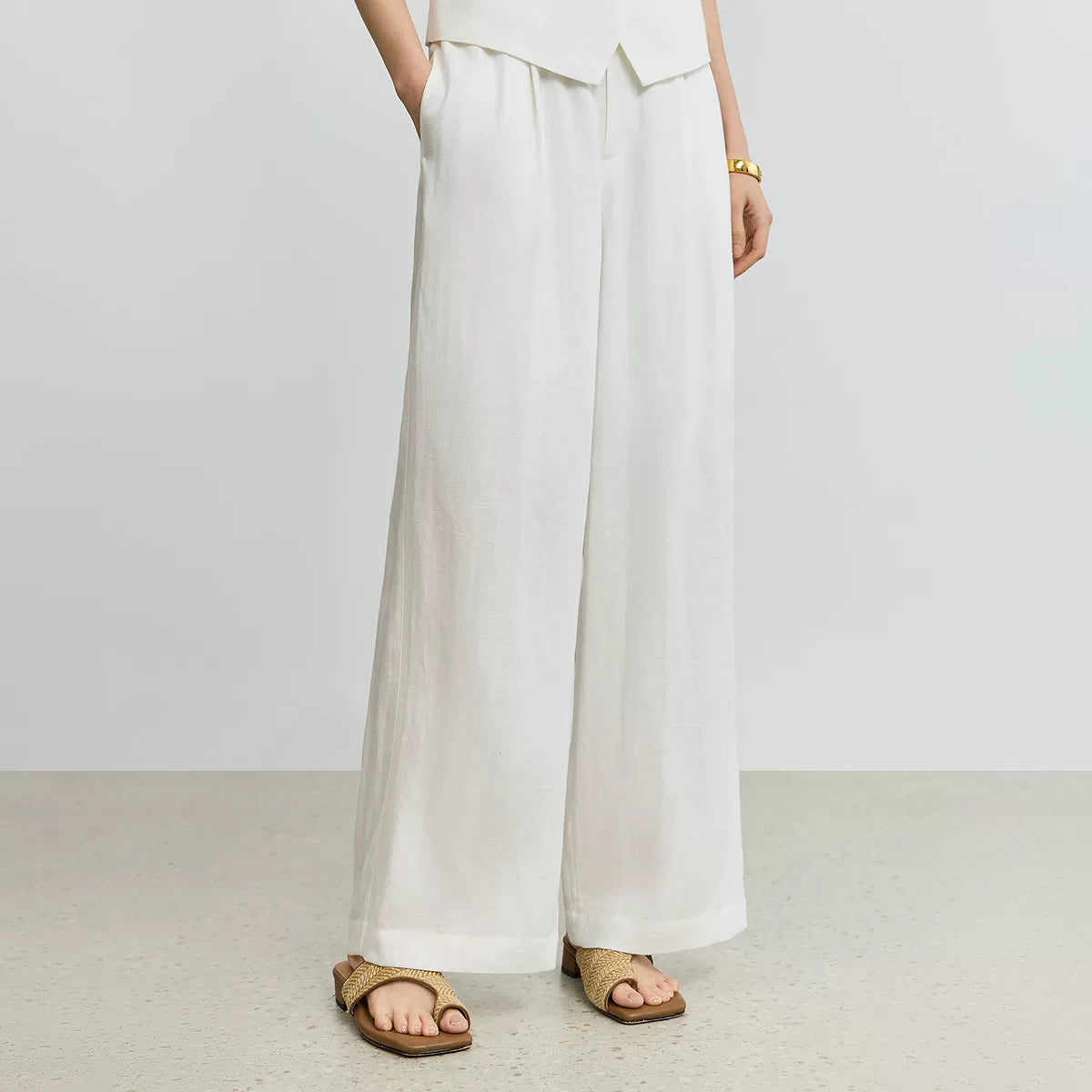 An irregular V-neck casual white vest with a breathable linen design